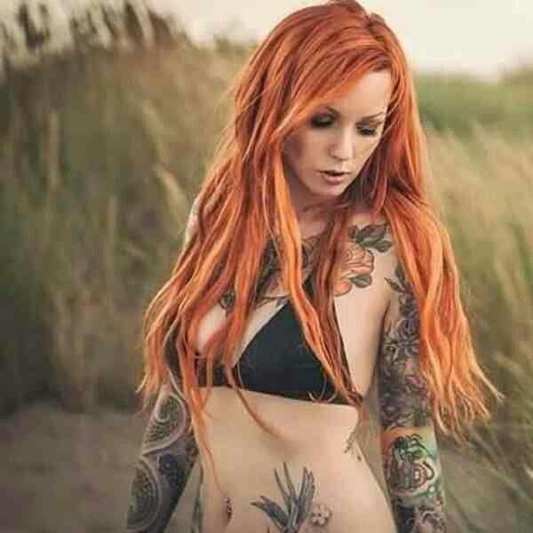 Busty tatooed redhead